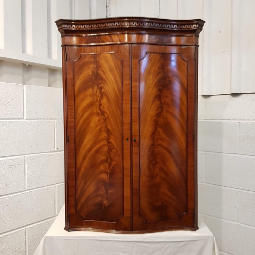 antique flamed mahogany serpentine front hanging corner cabinet c1920