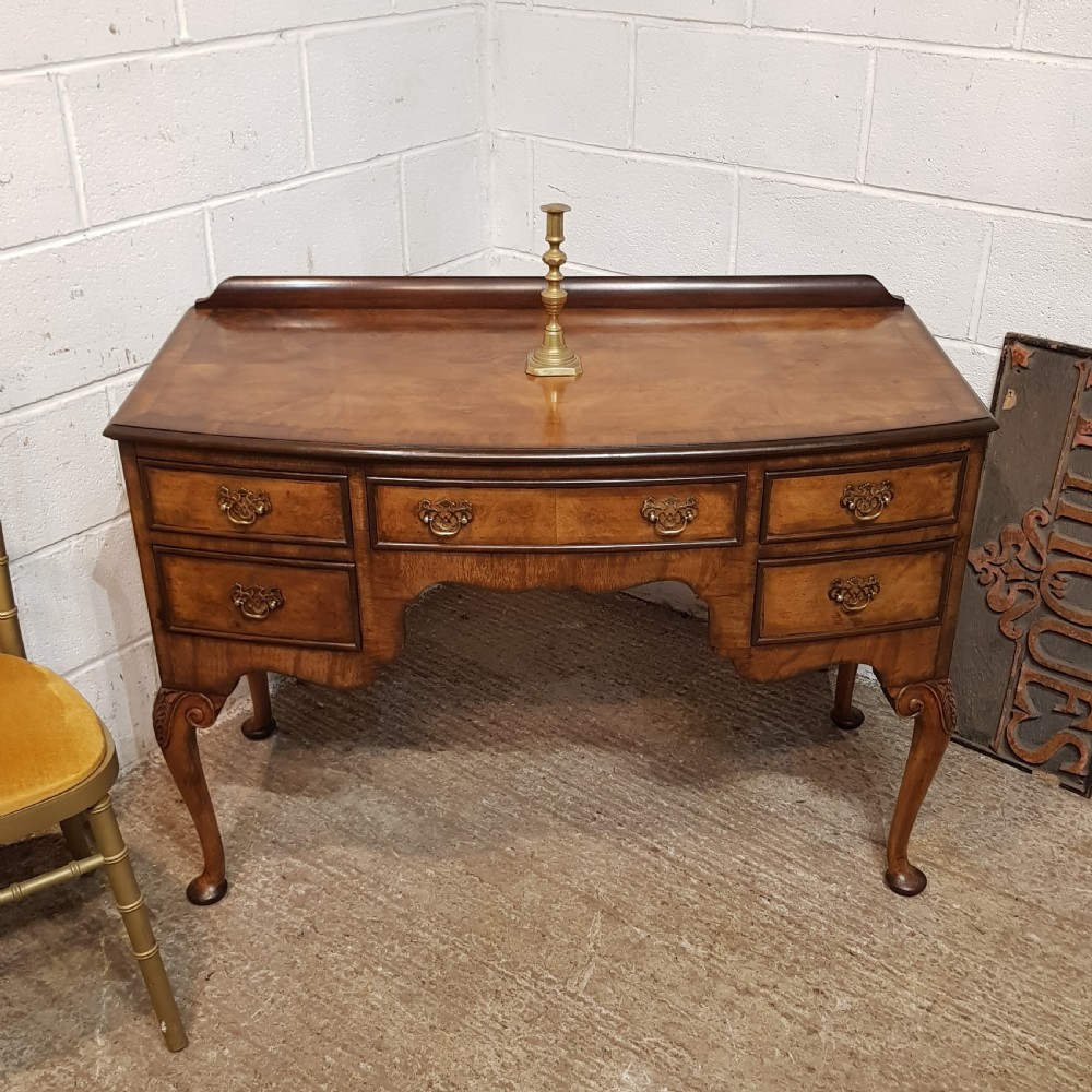 an antique bow fronted burr walnut dressing table c1920