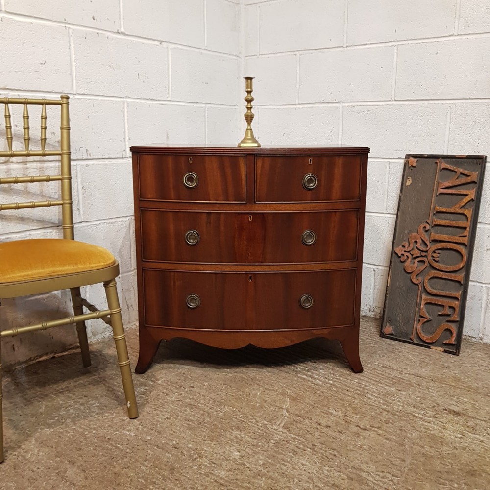 A SMALL WALNUT BOW FRONTED CHEST OF DRAWERS C1920 a small walnut bow fronted chest of drawers c1920