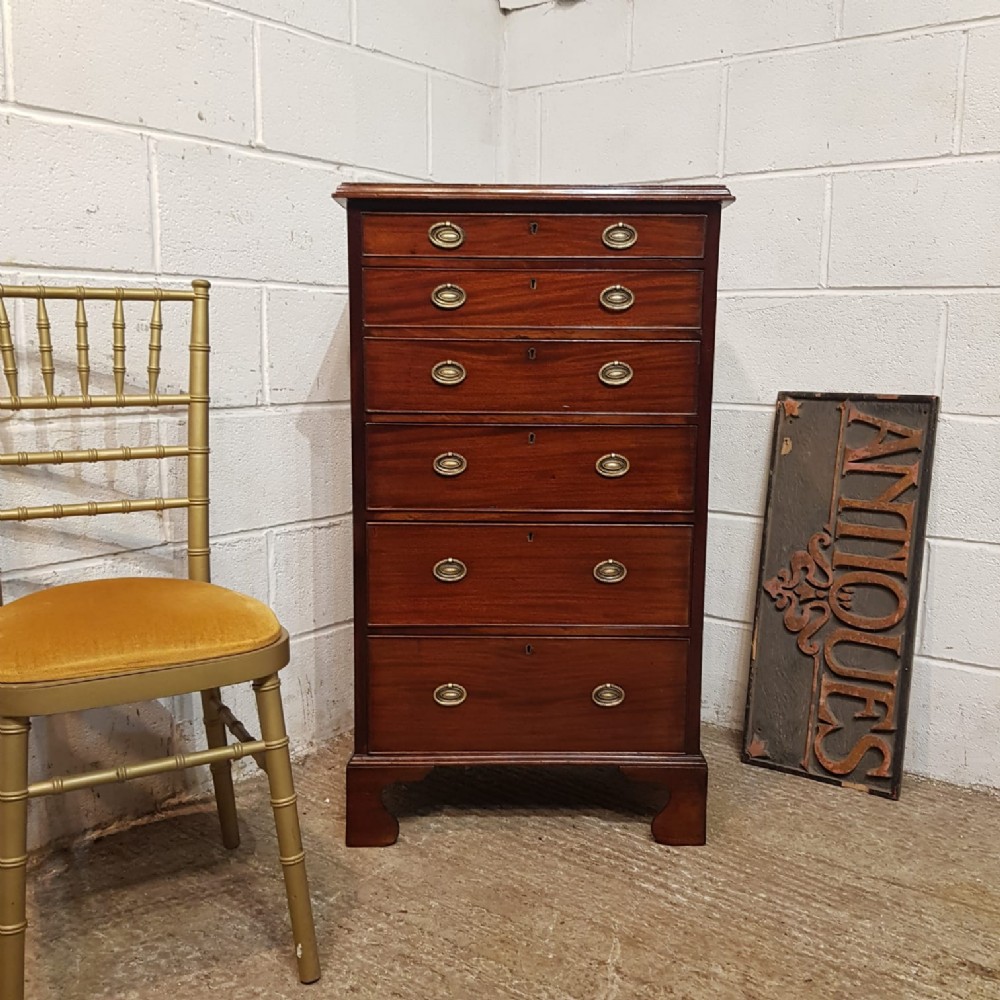 AN ANTIQUE TALL NARROW MAHOGANY CHEST OF DRAWERS C1890 an antique tall narrow mahogany chest of drawers c1890