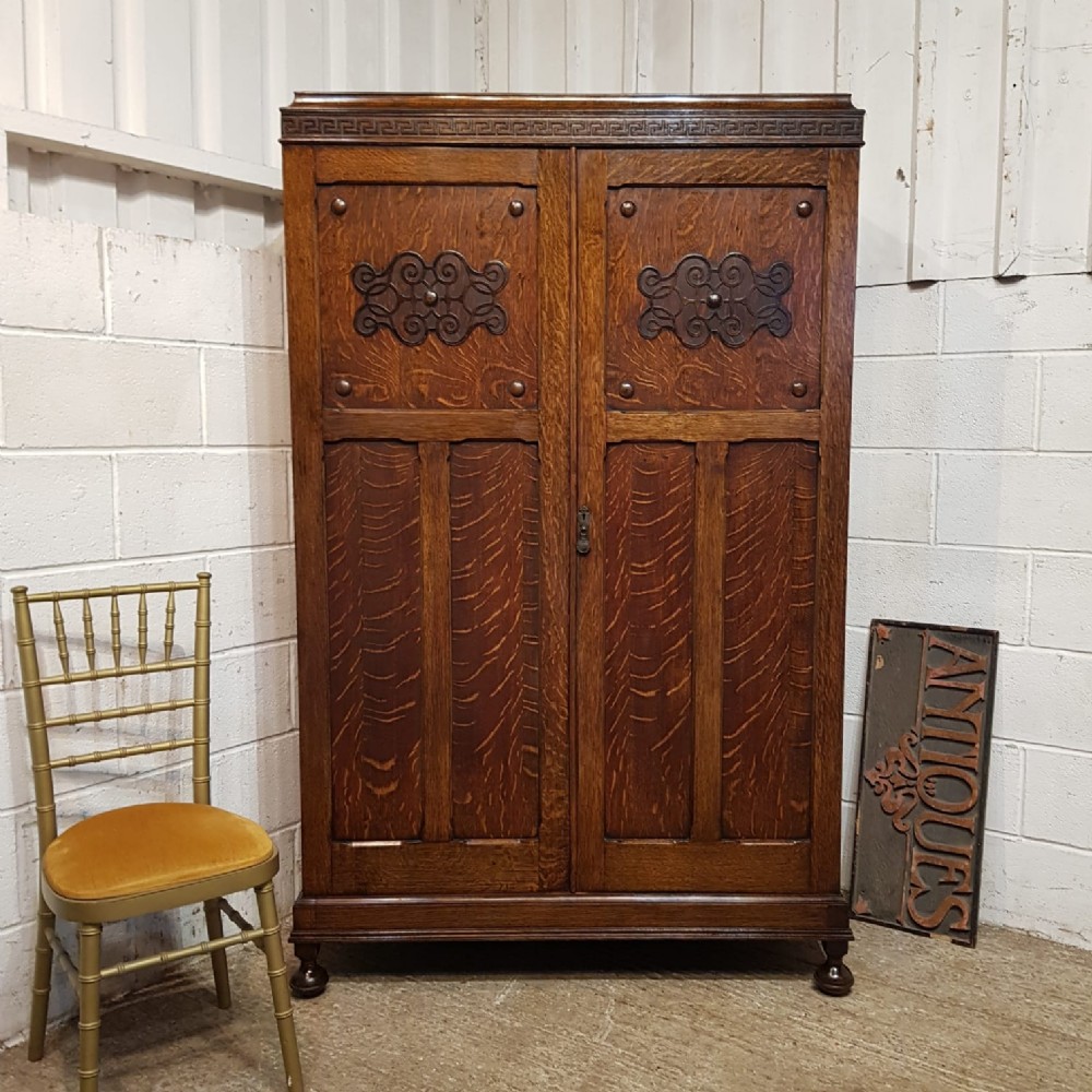 AN ANTIQUE OAK DOUBLE WARDROBE C1920 an antique oak double wardrobe c1920