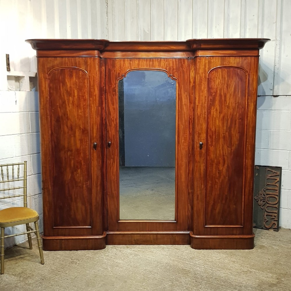 a victorian mahogany inverted breakfront triple wardrobe c1860