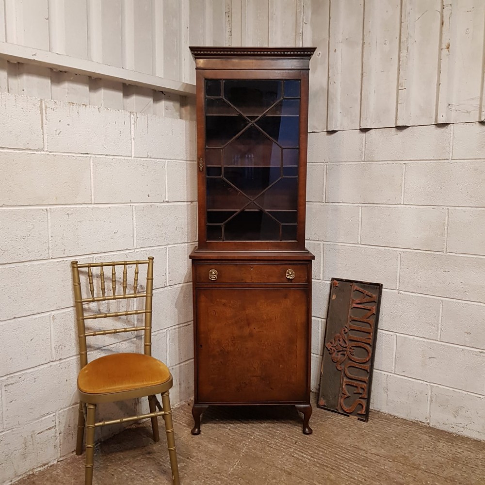 a walnut astragal glazed tall narrow bookcase on cupboard c1920