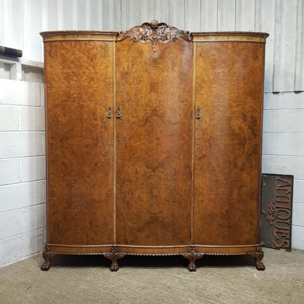 a burr walnut serpentine fronted triple wardrobe c1920